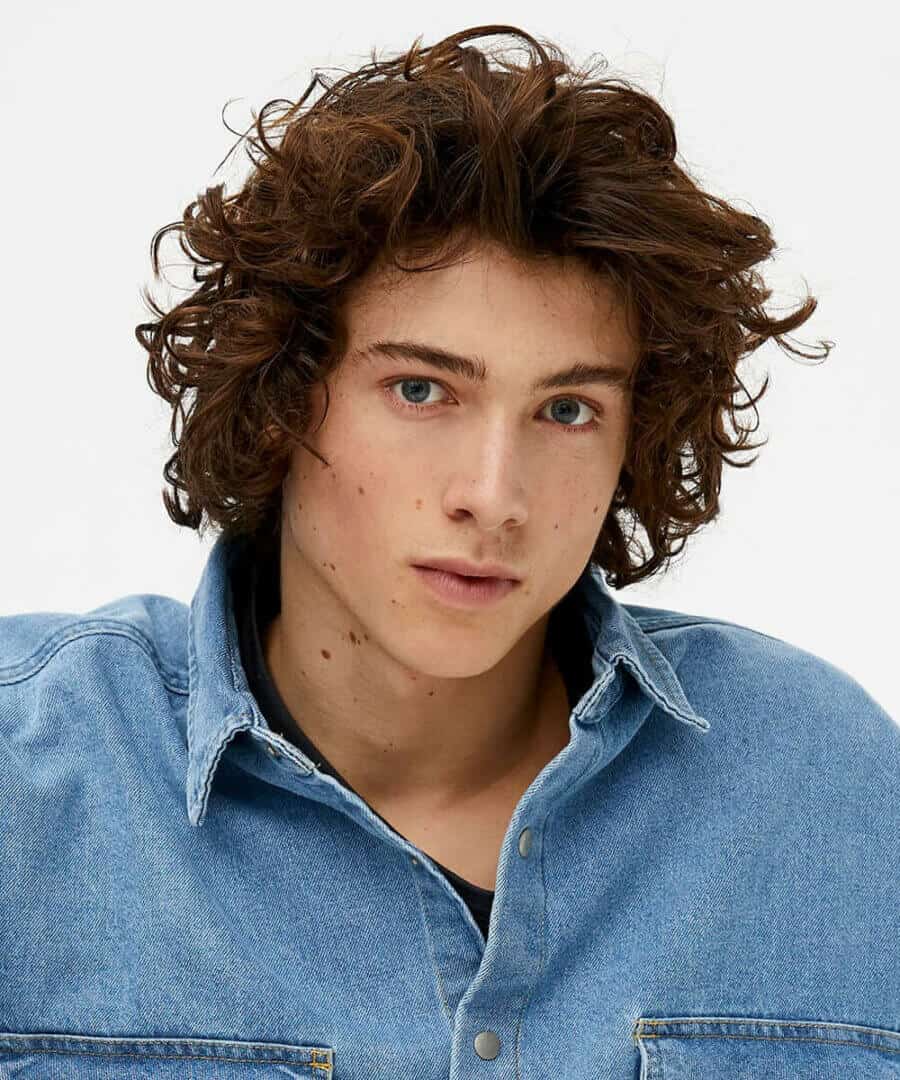 Messy mid-length to long curly hair for men