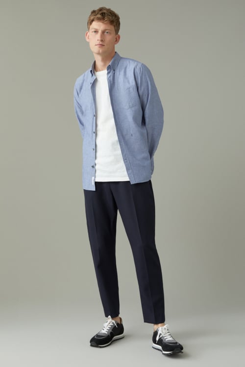 Men's layered summer outfit with white tee, blue open shirt and blue chinos