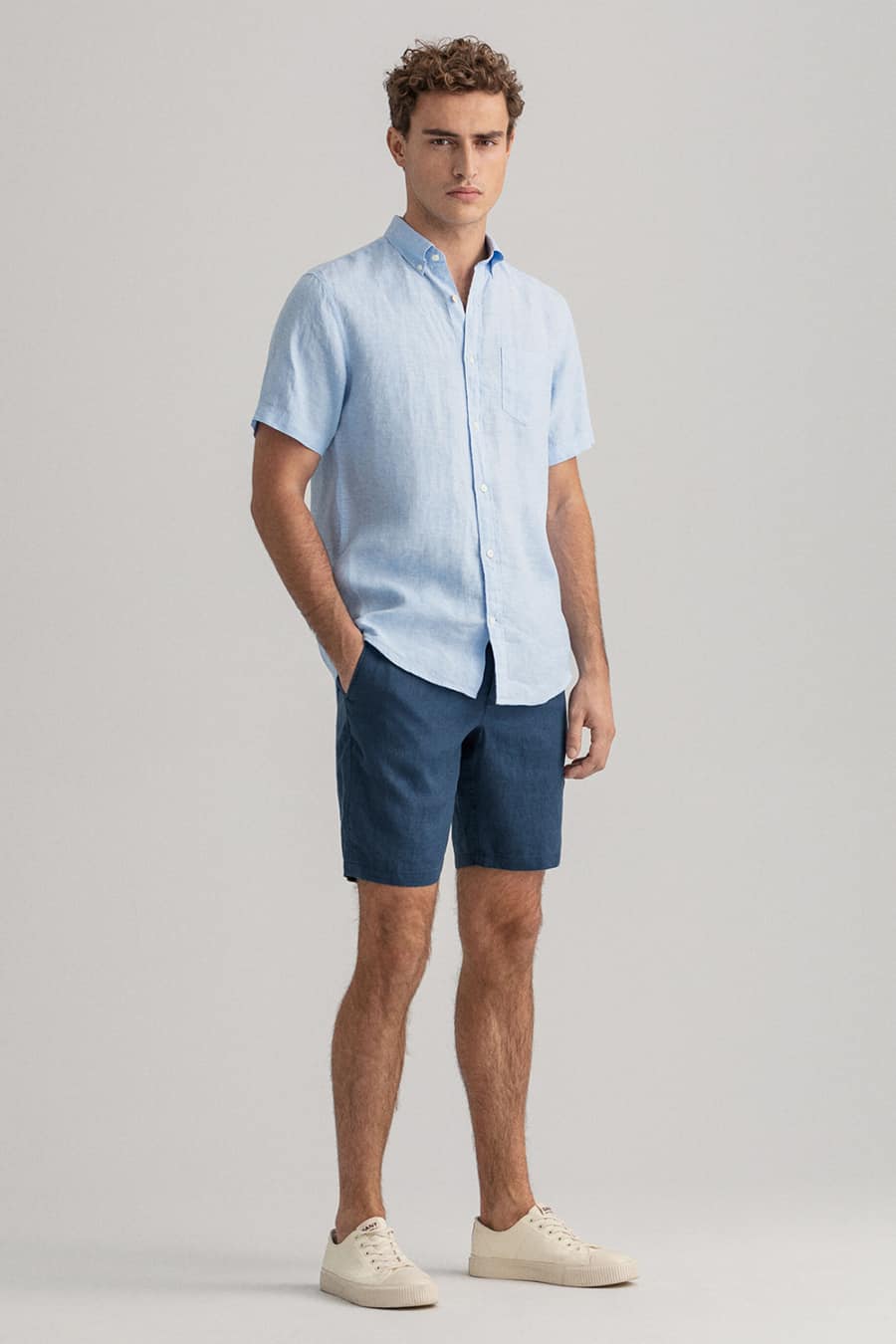 Men's short slevee button down shirt, shorts and sneakers outfit for men