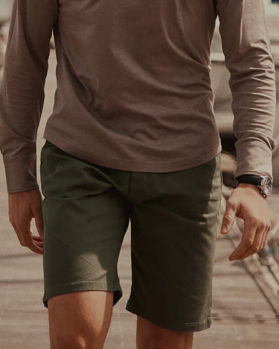 Men's chino shorts worn with long sleeve polo shirt