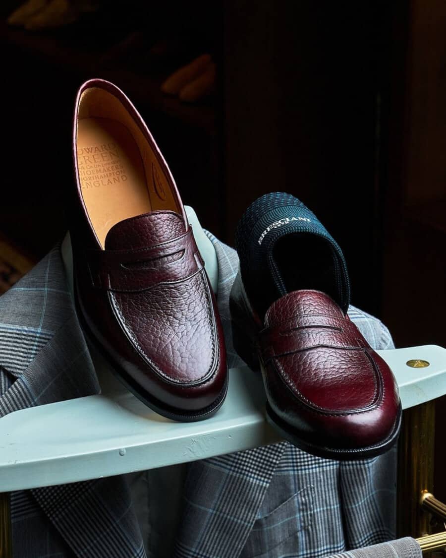A pair of luxury burgundy pebble leather Edward Green penny loafers