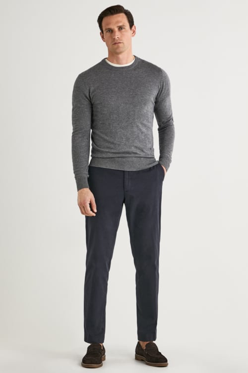Men's charcoal trousers, light grey sweater and loafers outfit
