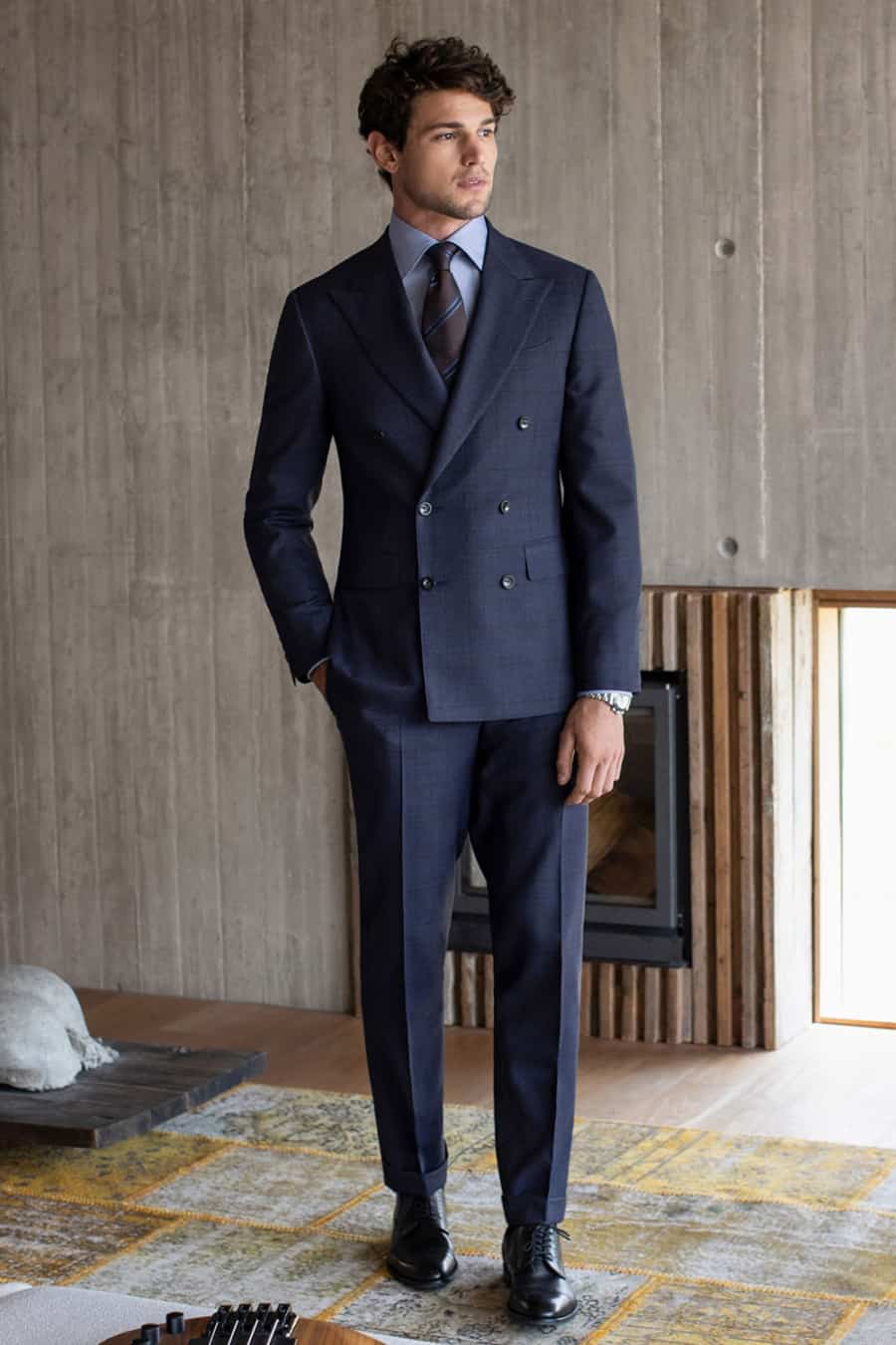 Men's navy double-breasted suit worn with black Derby shoes