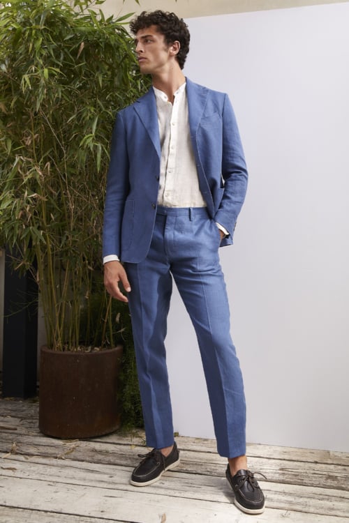 Men's bold blue suit with white grandad collar shirt and boat shoes outfit