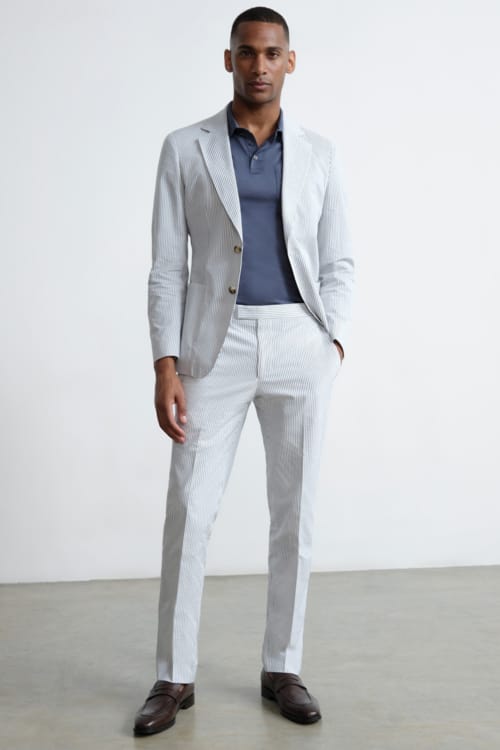 Men's striped seersucker suit with knitted polo shirt and loafers outfit