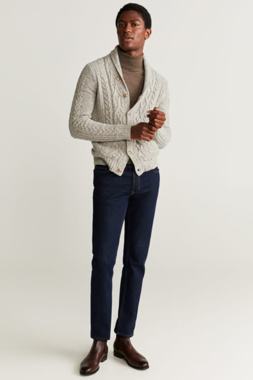Men's raw denim jeans, merino turtleneck, chunky cardigan and leather Chelsea boots outfit