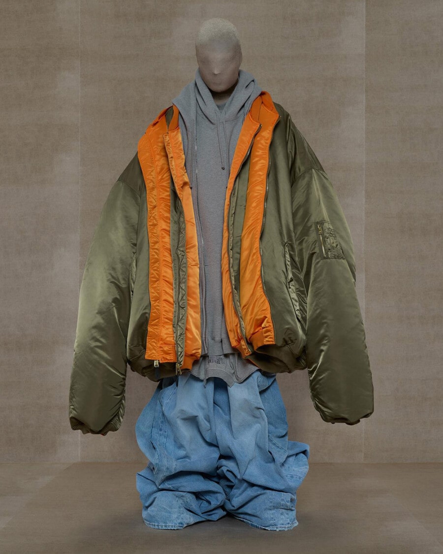 Dummy dressed in Vetements baggy light wash jeans, oversized grey hoodie and oversized green MA-1 bomber jacket