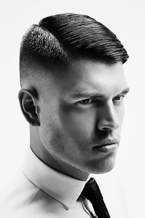Men's slick side parting hairstyle with mid fade