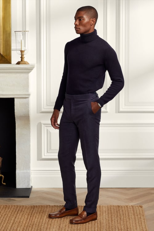 Men's smart tailored trousers, tucked in turtleneck and penny loafers outfit