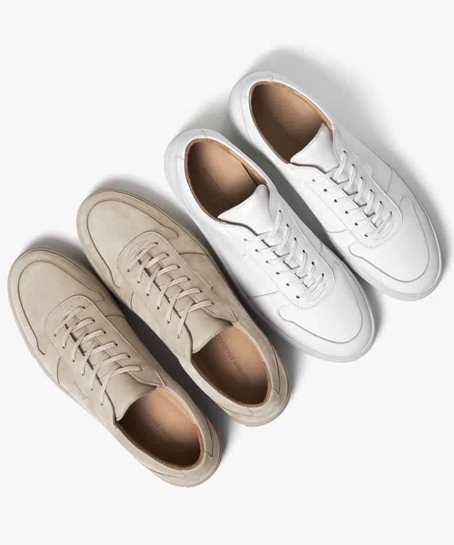 Two pairs of minimalist leather sneakers viewed from the top down