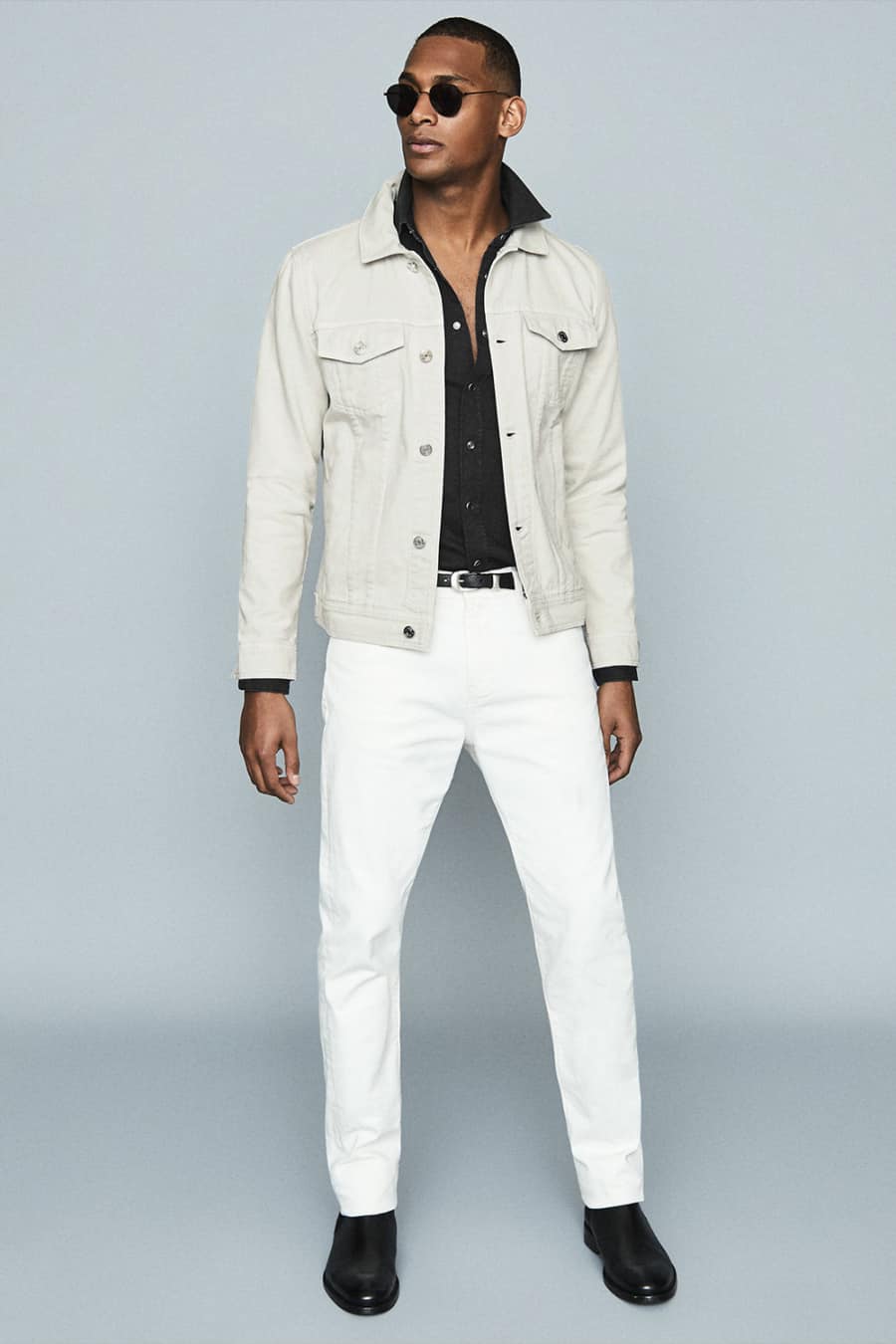 Men's white jeans, white denim jacket, black shirt and black boots outfit