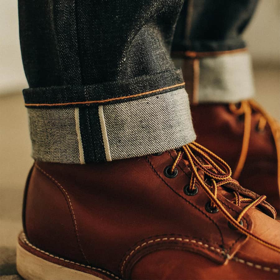 Men's work boots worn with turned up selvedge denim jeans