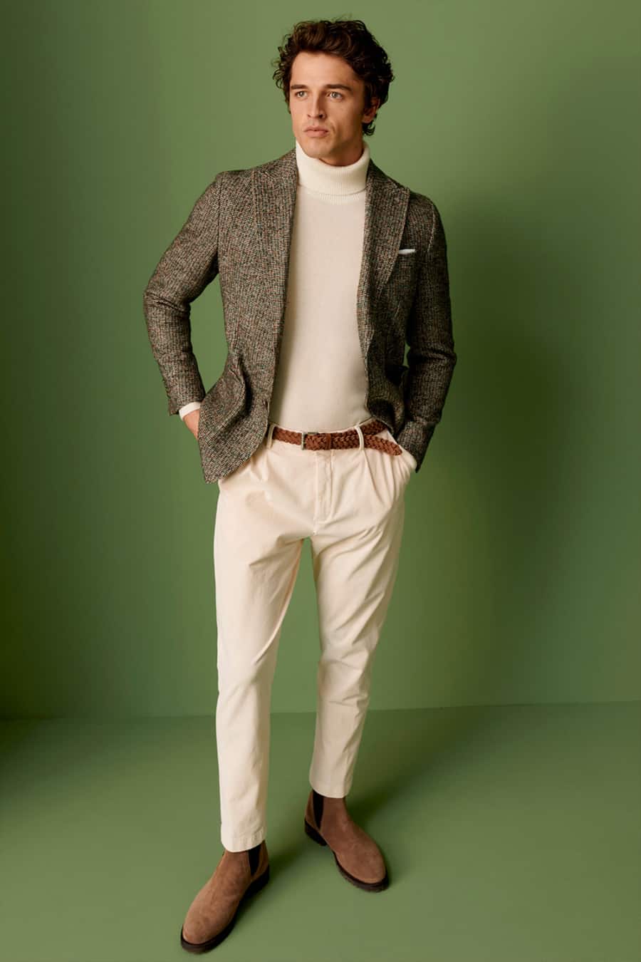 Men's cream pleated trousers, cream turtleneck, brown blazer and chelsea boots outfit