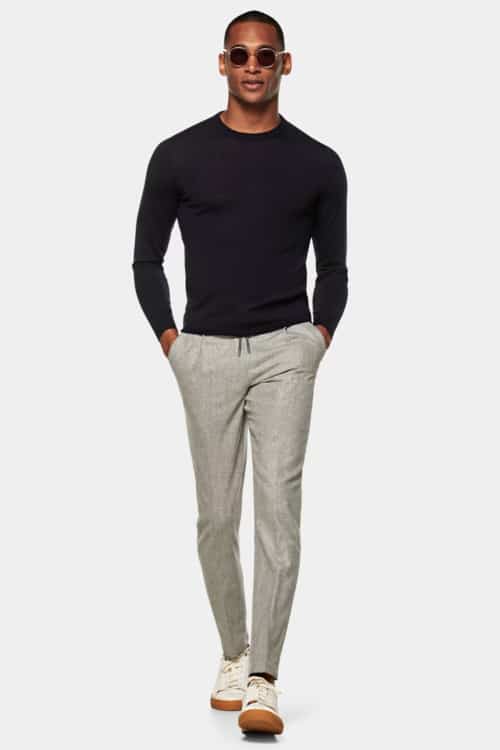 Men's grey drawstring pants, navy sweatshirt and sneakers outfit