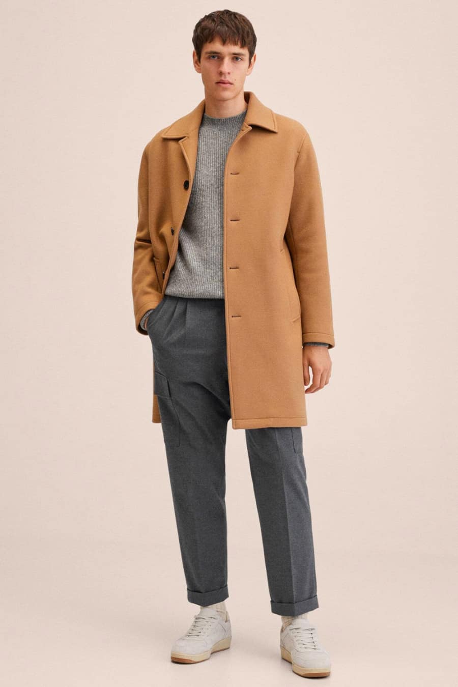 Grey trousers, jumper and sneakers with a camel overcoat outfit