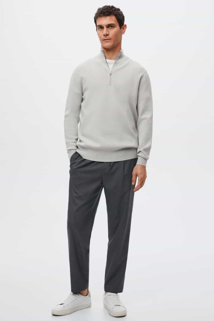 Men's charcoal drawstring pants, grey zip neck sweater and white sneakers outfit