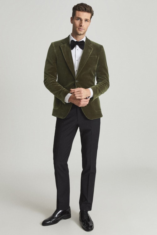 Men's black trousers, velvet dinner jacket, dress shirt and bow tie formal outfit