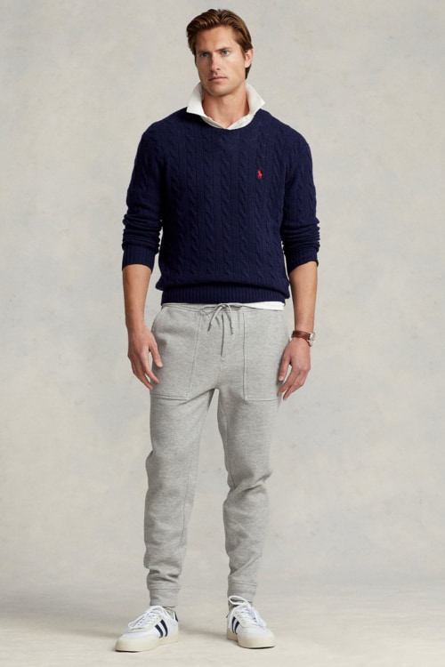 Men's grey sweatpants, oxford shirt, sweater and sneakers outfit