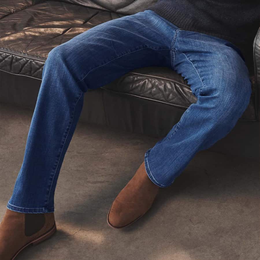 Men's slim blue jeans worn with suede Chelsea boots