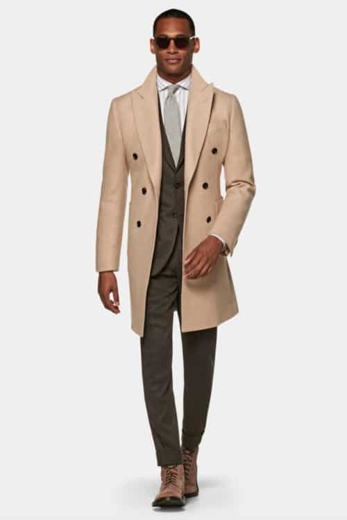 Men's olive green suit, striped shirt, camel overcoat and tan suede boots outfit