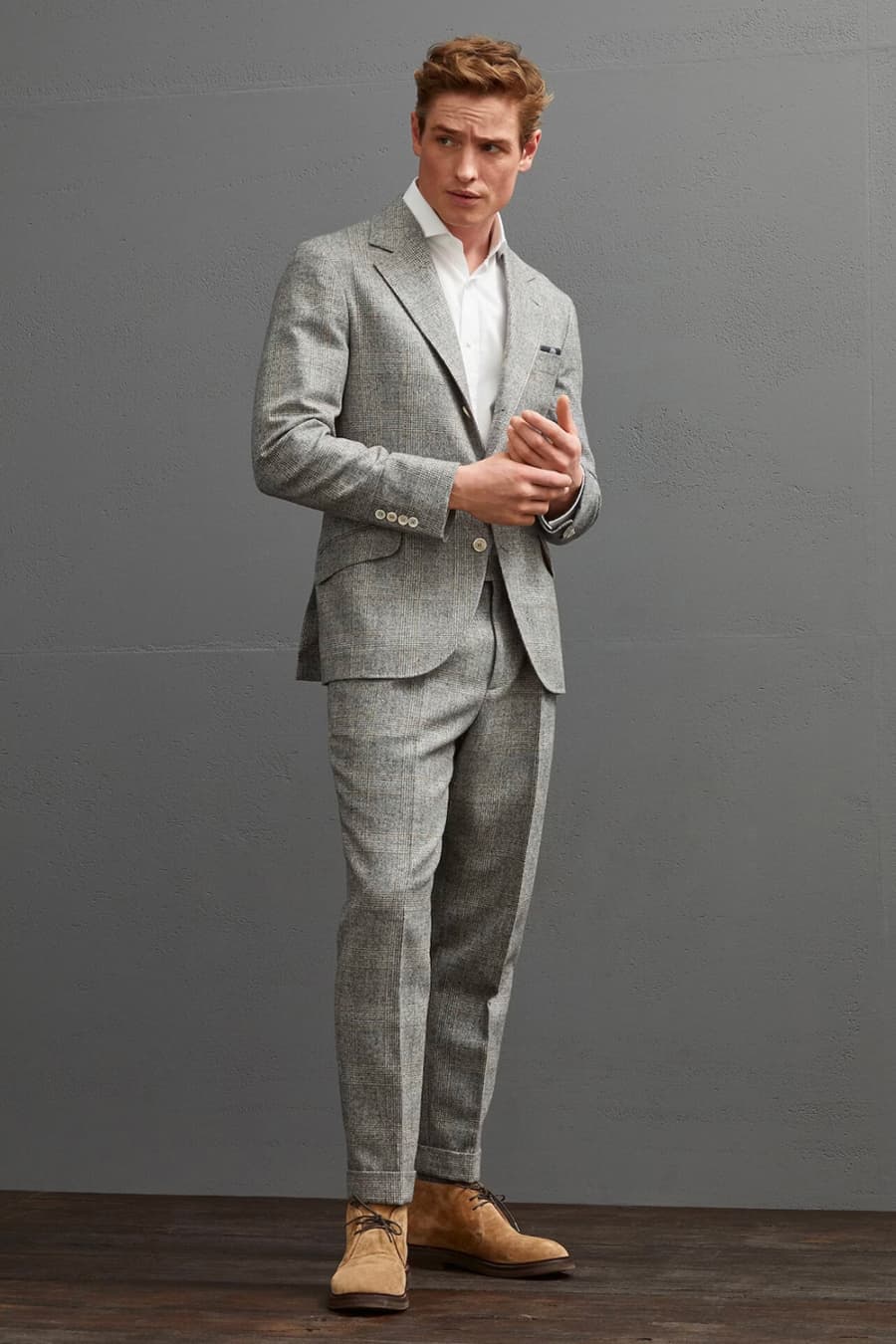 Men's grey wool check suit, white shirt and tan suede chukka boots outfit