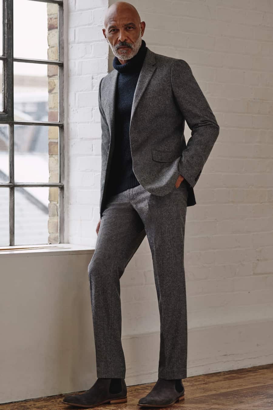 Men's flannel suit, ribbed navy turtleneck and grey suede Chelsea boots outfit