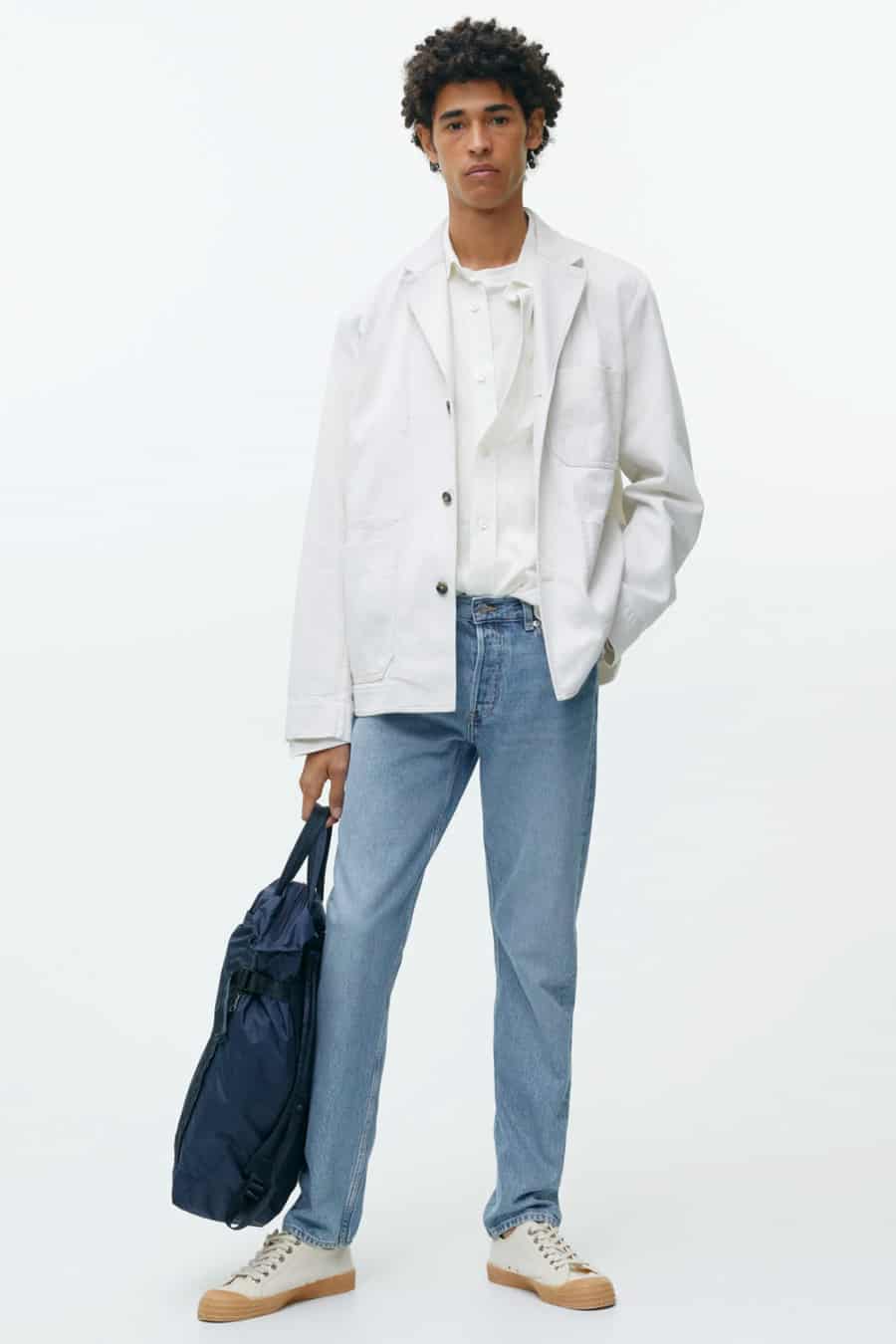 Men's light wash blue jeans with white T-shirt and white chore jacket outfit