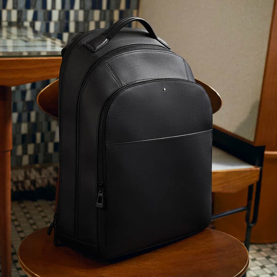 Montblanc sleek black luxury backpack on a chair