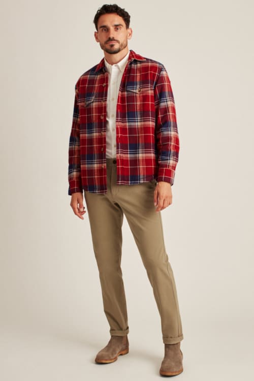 Men's khaki pants, white shirt and red plaid overshirt outfit with suede Chelsea boots