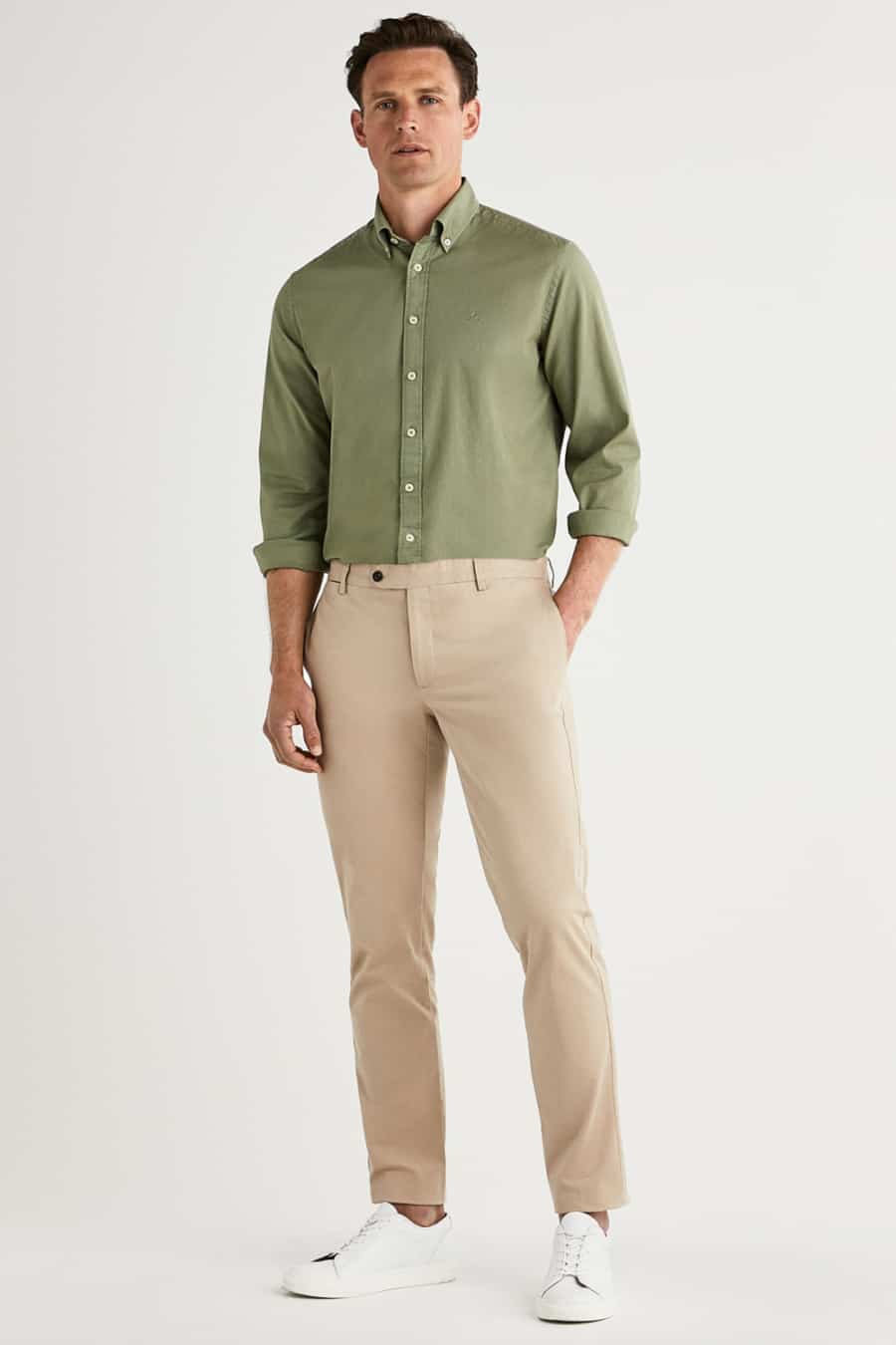 Men's khaki pants, green Oxford shirt and white sneakers outfit