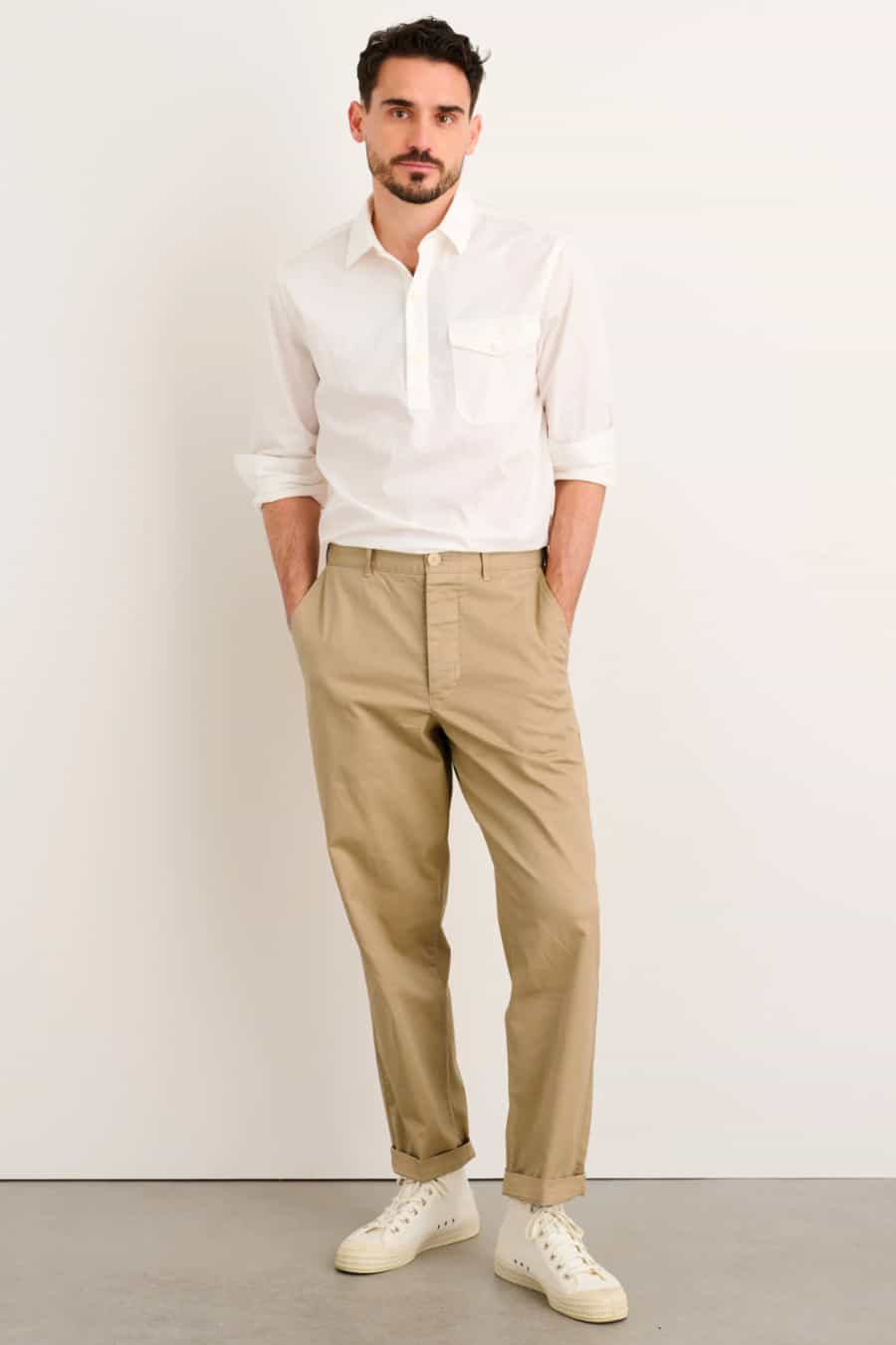 Men's khaki worker pants, tucked in white shirt, white sneakers outfit