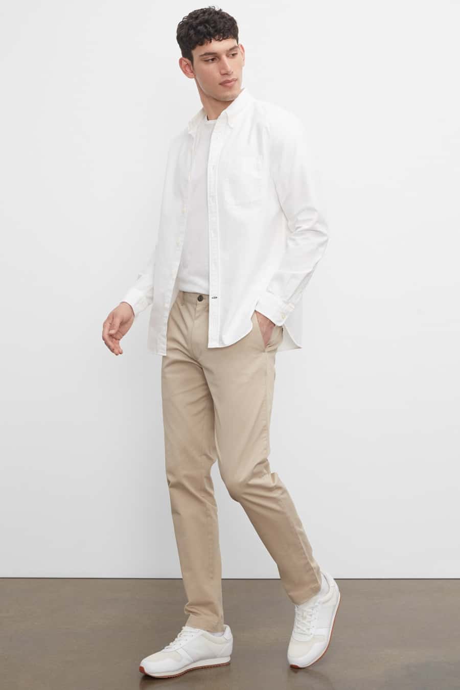 Men's khaki pants, white T-shirt, white open shirt and white sneakers outfit