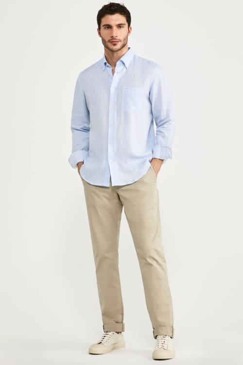 Men's khaki pants, light blue shirt, canvas sneakers outfit