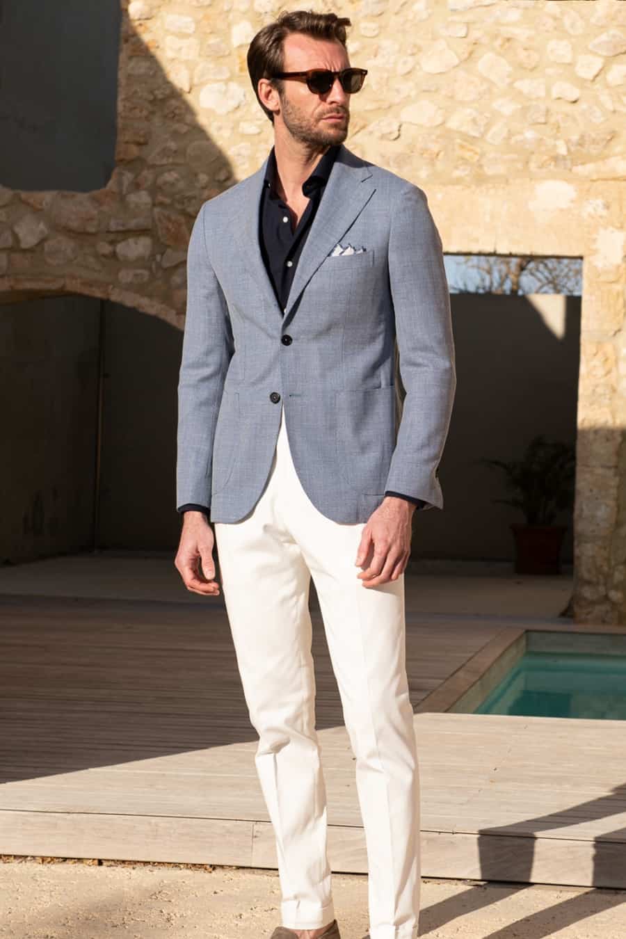 Men's tailored white pants, blue blazer and navy shirt outfit