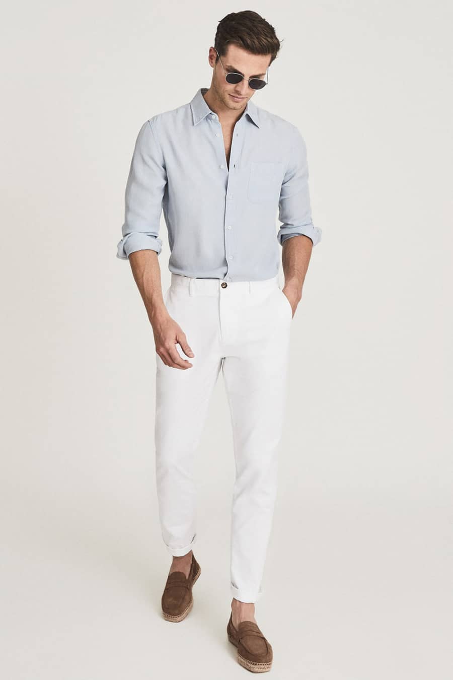 Men's white pants, light blue shirt and brown suede loafers outfit