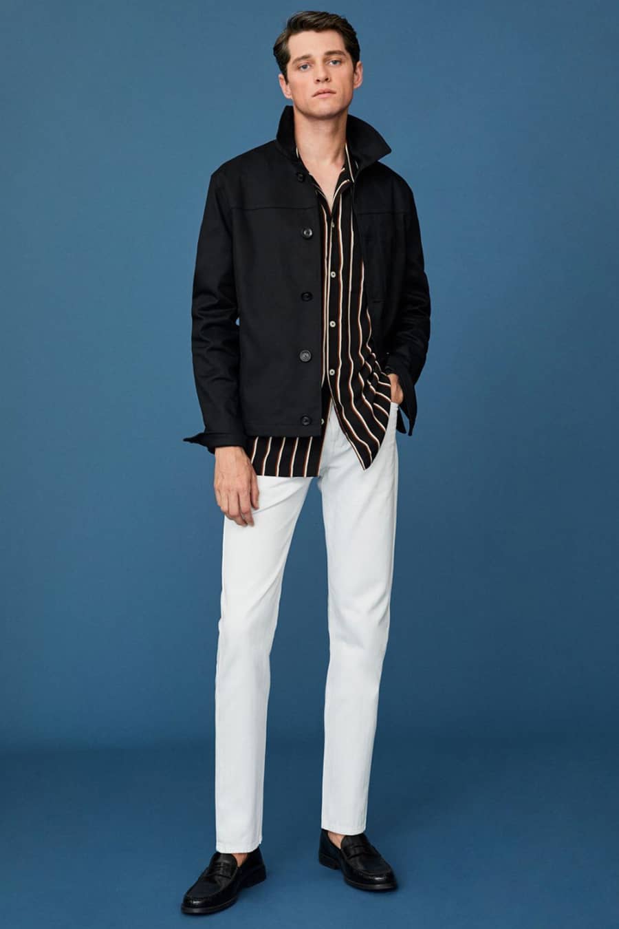 Men's white pants, black vertical striped shirt, black overshirt and black loafers outfit