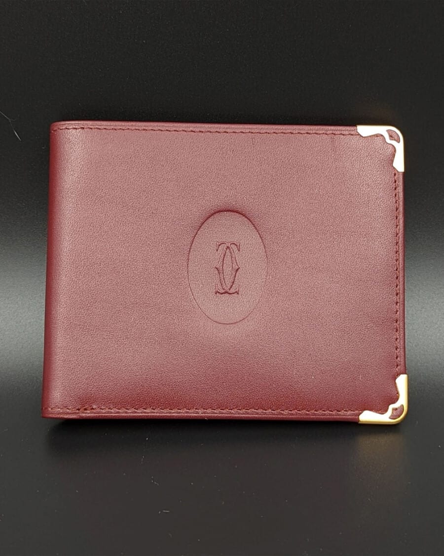 A red/burgundy leather luxury Cartier wallet for men