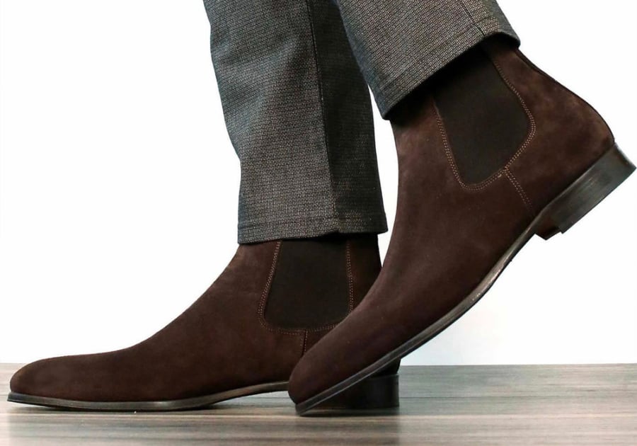 Men's Chelsea boots worn with suit trousers