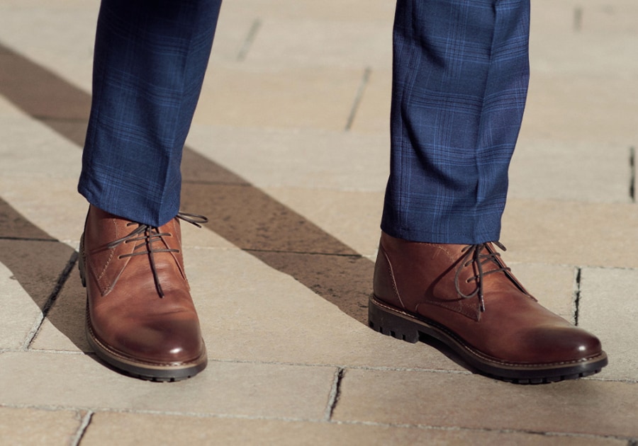 Men's desert/chukka boots worn with navy suit trousers