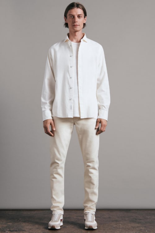 Men's all white outfit with white tapered jeans, white T-shirt and shirt