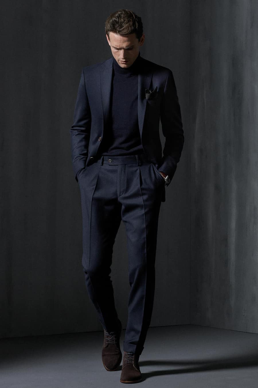 Men's navy lounge suit, turtleneck and suede boots outfit