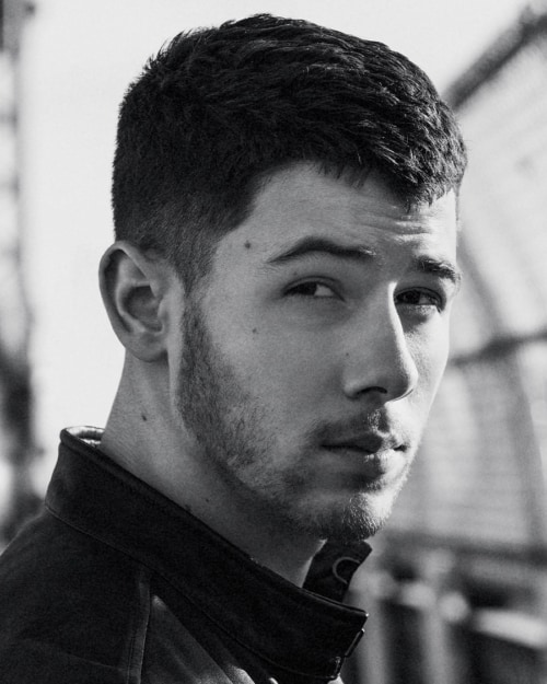 Nick Jonas short crew cut hairstyle with subtle low taper fade