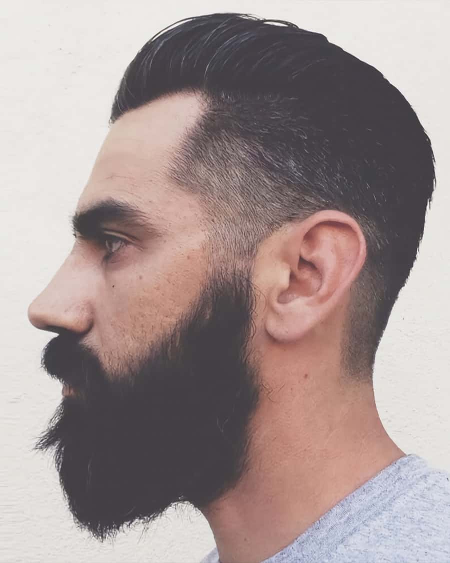 Men's slicked back hair with low taper fade