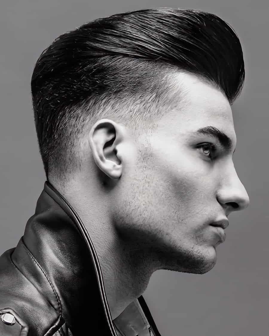 Men's sleek quiff hairstyle with low taper fade
