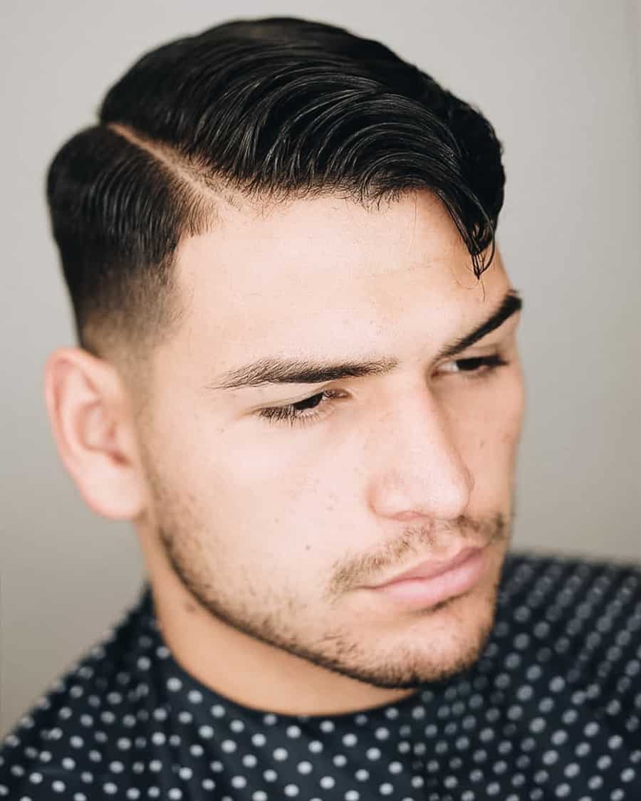 Men's hard parting with low temple fade haircut