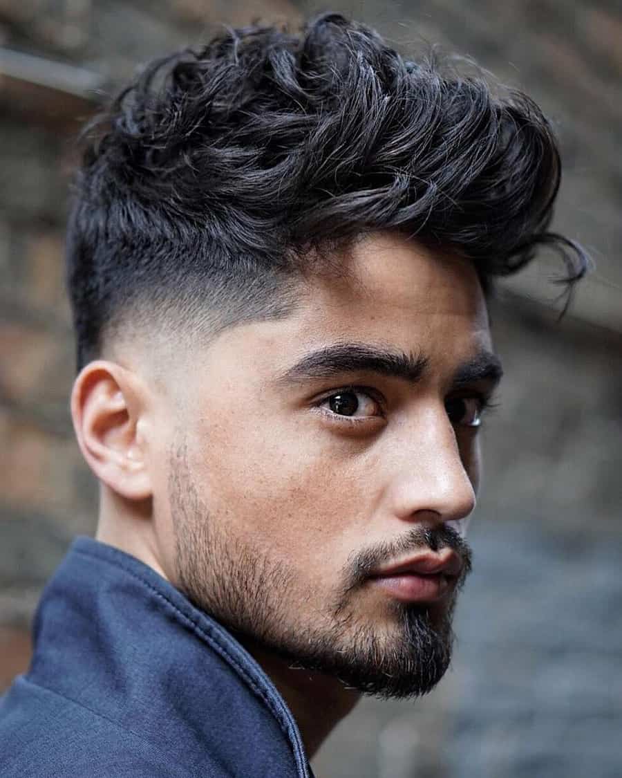 Men's textured messy pompadour with low taper fade