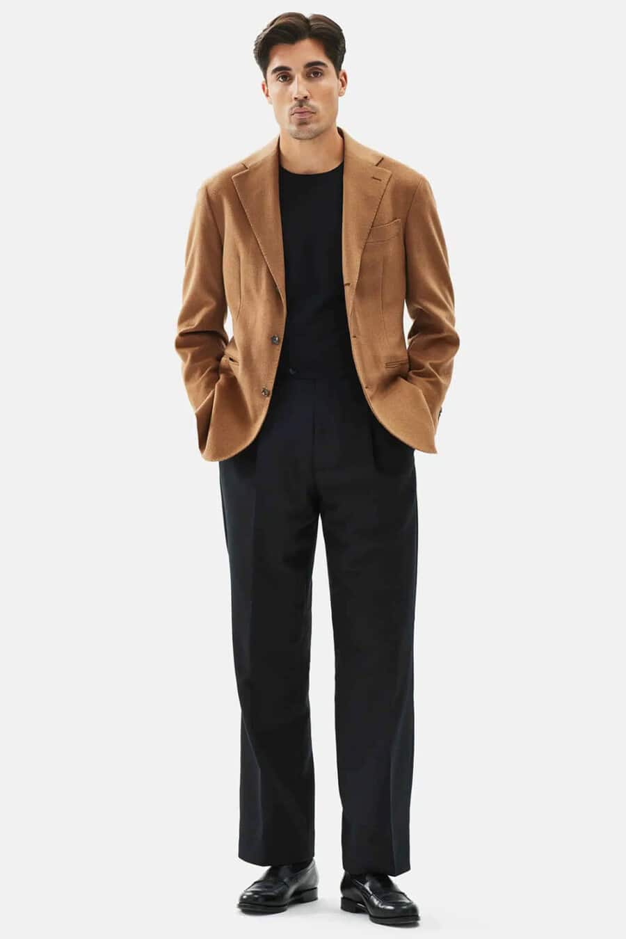 Men's wide-leg black pants, tucked in black T-shirt, tobacco brown blazer and black leather penny loafers smart-casual outfit