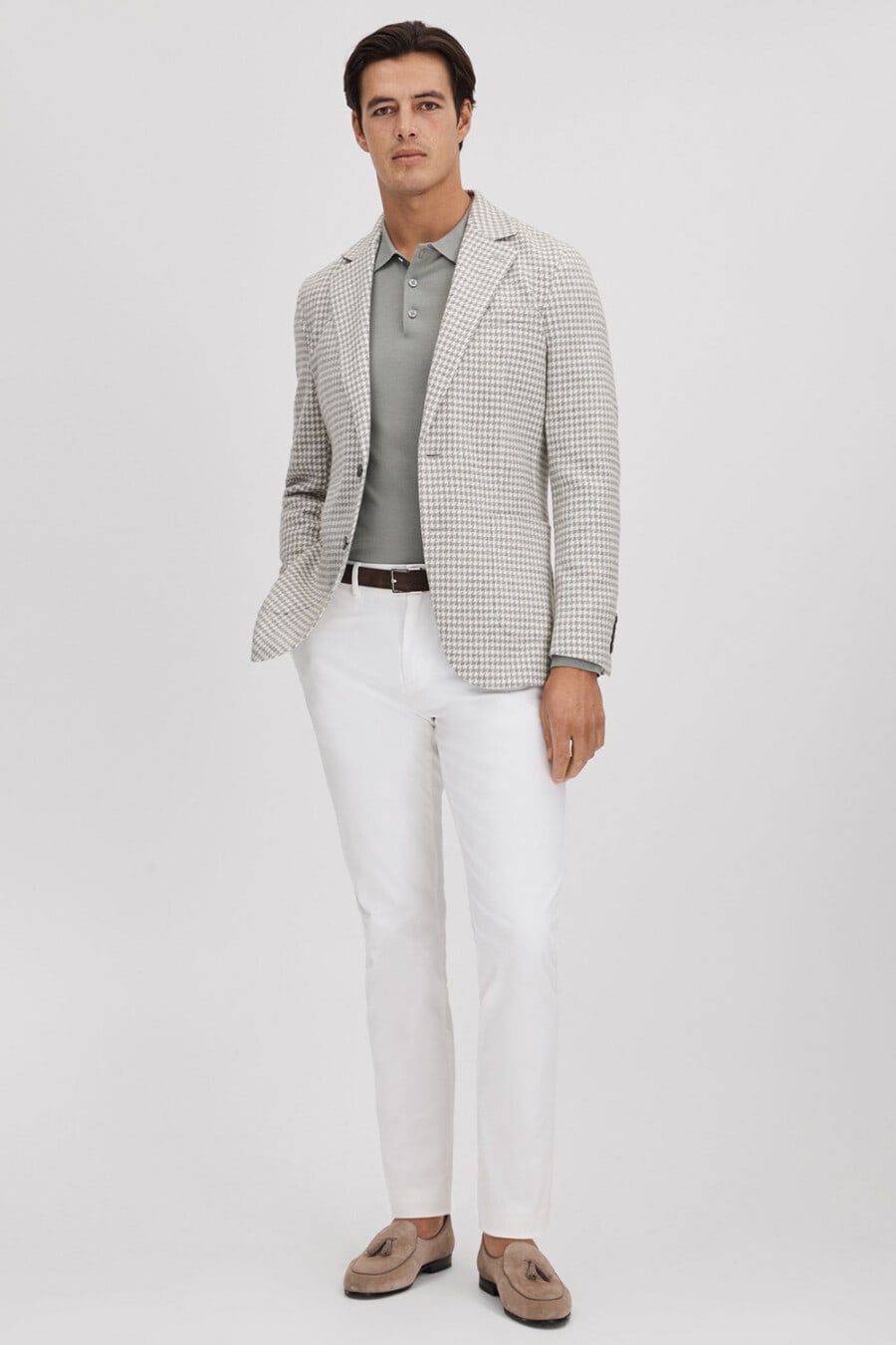 Men's white pants, grey tucked in polo shirt, white/grey check blazer and taupe suede tassel loafers smart-casual outfit