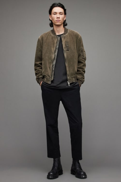 Men's black cropped trousers, charcoal T-shirt, green bomber jacket and black leather boots outfit