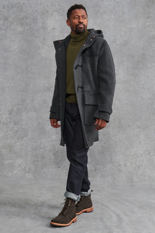 Men's raw denim jeans, green roll neck, grey duffle coat and brown boots outfit